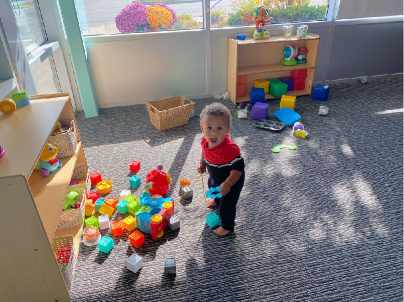 toddler playing with toys at The Toy Box Early Childhood Education Centre in Leamington Ontario