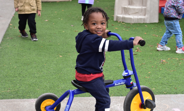 little-boy-riding-his-bike-at-The-toy-Box